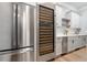 Kitchen with stainless steel fridge and wine cooler with white countertops and cabinetry at 5125 Avalaire Oaks Dr, Raleigh, NC 27614