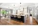 Spacious kitchen featuring a large island, modern lighting, and seamless access to the dining area at 5125 Avalaire Oaks Dr, Raleigh, NC 27614