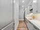 Bright kitchen features stainless steel appliances, white cabinets, and hardwood floors at 5125 Avalaire Oaks Dr, Raleigh, NC 27614