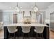 Stylish kitchen featuring a marble-top island, stainless steel appliances, and modern light fixtures at 5125 Avalaire Oaks Dr, Raleigh, NC 27614