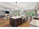 Open kitchen with a large island, bar seating, modern appliances, and access to the living area at 5125 Avalaire Oaks Dr, Raleigh, NC 27614
