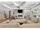 Cozy living room features a modern fireplace, plush seating, and access to the backyard at 5125 Avalaire Oaks Dr, Raleigh, NC 27614