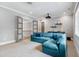 Bright living room featuring a comfortable blue sectional sofa and entertainment area at 5125 Avalaire Oaks Dr, Raleigh, NC 27614