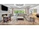Bright, open living room with a fireplace, comfortable seating, and seamless access to the pool at 5125 Avalaire Oaks Dr, Raleigh, NC 27614