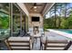 Inviting outdoor living space with stone fireplace and covered seating area overlooking the pool at 5125 Avalaire Oaks Dr, Raleigh, NC 27614