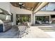 Covered outdoor patio featuring a built-in grill, dining table and chairs, with ample seating for entertaining guests at 5125 Avalaire Oaks Dr, Raleigh, NC 27614