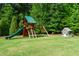 A classic playground with swing set, slide, climbing ropes and a playhouse offer hours of fun in the backyard at 5125 Avalaire Oaks Dr, Raleigh, NC 27614