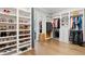 Spacious walk-in closet with custom shelves and rods, showcasing an organized wardrobe and shoe collection at 5125 Avalaire Oaks Dr, Raleigh, NC 27614