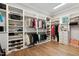 Large walk-in closet with custom shelving, hanging rods, and ample storage for clothing and accessories at 5125 Avalaire Oaks Dr, Raleigh, NC 27614