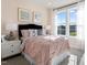 Cozy bedroom with soft pink walls, comfortable bed, bright natural light, and charming decor, perfect for relaxation at 5906 Dunzo Dr, Raleigh, NC 27617