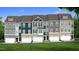 Charming townhome exterior showcasing multiple units, each with unique color schemes and stone accents on the lower level at 5906 Dunzo Dr, Raleigh, NC 27617