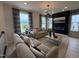 Inviting living room featuring a modern fireplace, stylish light fixture, plush seating, and large windows with scenic views at 5906 Dunzo Dr, Raleigh, NC 27617