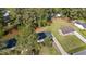 An aerial view shows the house and backyard; surrounded by many mature trees at 623 Lincoln Dr, Kenly, NC 27542