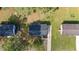 Aerial view of the roof with driveway and backyard of neighboring houses and mature trees at 623 Lincoln Dr, Kenly, NC 27542