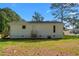 Back exterior of home showing vinyl siding and wooden steps to backyard at 623 Lincoln Dr, Kenly, NC 27542
