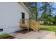 Exterior view of the back porch of the house with wooden railing and steps to backyard at 623 Lincoln Dr, Kenly, NC 27542