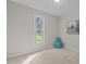 Cozy bedroom with natural light from a window and an inviting blue ottoman at 623 Lincoln Dr, Kenly, NC 27542