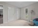 Neutral-toned bedroom features a window, with a blue ottoman and carpeted floors at 623 Lincoln Dr, Kenly, NC 27542