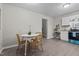 Inviting dining area with a round table, wicker chairs, and modern laminate flooring leading into the kitchen at 623 Lincoln Dr, Kenly, NC 27542