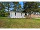 A charming home displays well-kept vinyl siding and an expansive yard, complemented by mature trees at 623 Lincoln Dr, Kenly, NC 27542