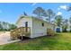 White siding with newly installed wooden deck and steps leading to the backyard on a sunny day at 623 Lincoln Dr, Kenly, NC 27542