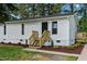 The front entrance boasts a well-maintained vinyl exterior, complemented by a freshly built wooden stairway at 623 Lincoln Dr, Kenly, NC 27542