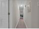 Bright hallway with wood-look flooring leads to a living area with comfortable seating at 623 Lincoln Dr, Kenly, NC 27542