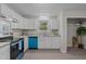 Bright kitchen featuring white cabinets, granite countertops, and stainless steel appliances with blue accents at 623 Lincoln Dr, Kenly, NC 27542