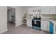 Bright kitchen featuring white cabinets, granite countertops, and stainless steel appliances with blue accents at 623 Lincoln Dr, Kenly, NC 27542