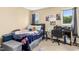 This bedroom includes two windows, a desk area, and a comfortable bed topped with colorful pillows and a cozy blanket at 700 Martin Luther King Jr Blvd # A6, Chapel Hill, NC 27514