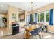 Cozy dining room featuring a modern light fixture, large windows and view to kitchen at 700 Martin Luther King Jr Blvd # A6, Chapel Hill, NC 27514
