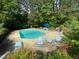This community pool area offers lounge chairs and umbrellas for relaxation surrounded by lush greenery at 700 Martin Luther King Jr Blvd # A6, Chapel Hill, NC 27514