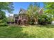 Side view of home with brick facade, screened in porch and lawn at 708 Mill Pointe Way, Elon, NC 27244