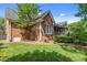 Side view of home with brick facade, screened in porch and lawn at 708 Mill Pointe Way, Elon, NC 27244