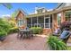 A brick patio features outdoor seating and a screened-in porch at 708 Mill Pointe Way, Elon, NC 27244