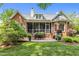 A brick patio features outdoor seating and a screened-in porch at 708 Mill Pointe Way, Elon, NC 27244