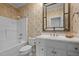 Cozy bathroom featuring a shower-tub combo, vanity, and floral wallpaper at 708 Mill Pointe Way, Elon, NC 27244