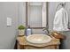 Powder room with decorative sink, patterned wallpaper and vintage mirror at 708 Mill Pointe Way, Elon, NC 27244
