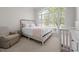 Bedroom featuring a large window, neutral decor, and a comfortable armchair at 708 Mill Pointe Way, Elon, NC 27244