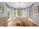 Bright dining area features a round table, chandelier, and large windows with a wooded view at 708 Mill Pointe Way, Elon, NC 27244