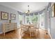 Charming dining area with round table, decorative chandelier, and bright windows with wooded view at 708 Mill Pointe Way, Elon, NC 27244