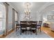 Elegant dining room with hardwood floors, large table and chairs, and decorative chandelier at 708 Mill Pointe Way, Elon, NC 27244