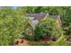 Aerial side view of a red brick home with mature trees at 708 Mill Pointe Way, Elon, NC 27244