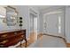 Bright foyer features hardwood floors, chandelier, decorative mirror, and arched doorway at 708 Mill Pointe Way, Elon, NC 27244