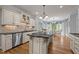 Open kitchen with custom cabinets, a large center island, stainless steel appliances, and breakfast nook at 708 Mill Pointe Way, Elon, NC 27244