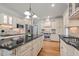 Well-appointed kitchen with a large center island, stainless steel appliances, and custom cabinetry at 708 Mill Pointe Way, Elon, NC 27244