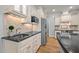 Bright kitchen featuring stainless steel appliances, stone countertops, and decorative backsplash at 708 Mill Pointe Way, Elon, NC 27244