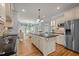 Bright kitchen with custom cabinets, a large center island, stainless steel appliances, and breakfast nook at 708 Mill Pointe Way, Elon, NC 27244
