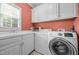 Bright laundry room with sink, washer, dryer, and ample cabinet space at 708 Mill Pointe Way, Elon, NC 27244
