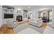 Bright living room with a fireplace, built-in shelving, hardwood floors, and comfortable furniture at 708 Mill Pointe Way, Elon, NC 27244